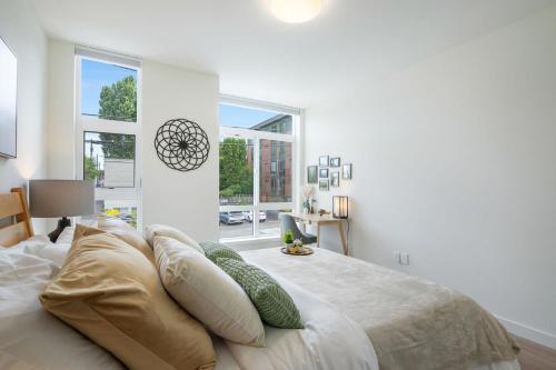 a bedroom with a bed with pillows and a window at Howell Haven 19 BY Betterstay in Seattle