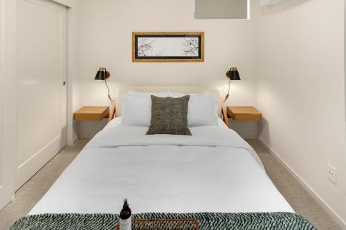 a large white bed in a room with two lamps at Metro Malden BY Betterstay in Seattle