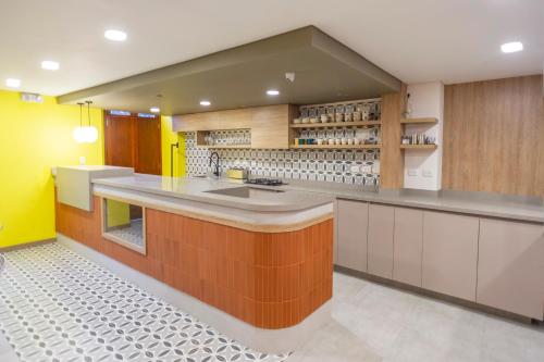 a kitchen with a large island in the middle at Siete Balcones Hotel y Coworking in Pasto