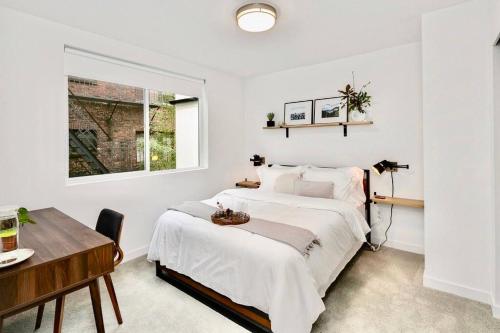 a bedroom with a bed and a desk and a window at Capitol Luxe Eight BY Betterstay in Seattle