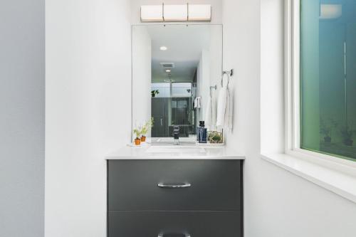 a bathroom with a sink and a mirror at Belmont Boutique 2 BY Betterstay in Seattle