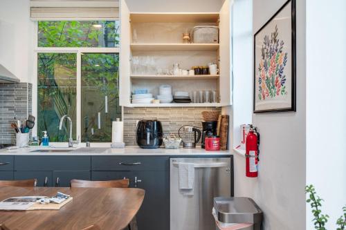 a kitchen with a wooden table and a sink at Belmont Boutique 4 BY Betterstay in Seattle
