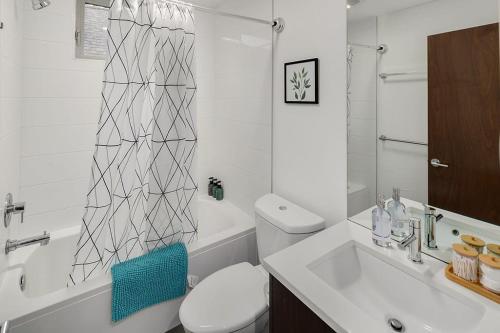 a bathroom with a toilet and a sink and a shower at Centro House A BY Betterstay in Seattle