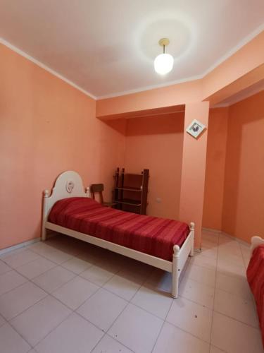 um quarto com uma cama com um cobertor vermelho em Dpto Villa em Marengo