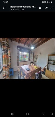 a picture of a living room with a table at 9 amigos in Villa Gesell
