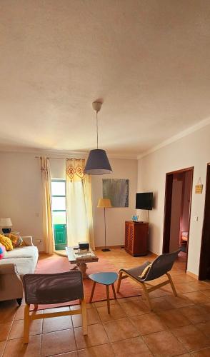 a living room with a couch and a table at Casa da Ti Bia in Setúbal