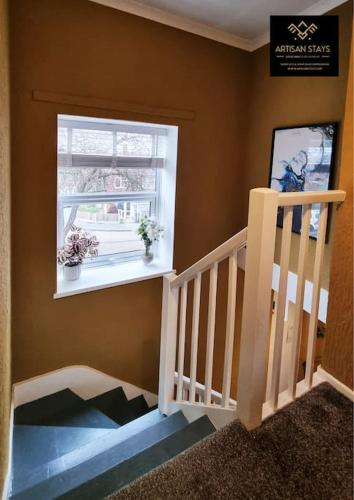 a staircase in a room with a window at The Rose Garden of Basildon in the Heart of Basildon by Artisan Stays I Weekly or Monthly Stay Offer I Pvt Parking I Sleeps 6 in Basildon