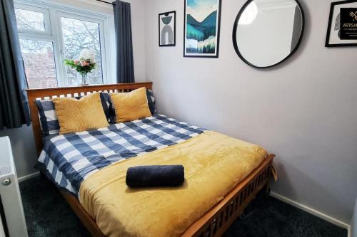 a bedroom with a bed with a mirror on the wall at The Rose Garden of Basildon in the Heart of Basildon by Artisan Stays I Weekly or Monthly Stay Offer I Pvt Parking I Sleeps 6 in Basildon