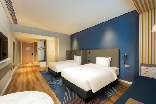 Ένα ή περισσότερα κρεβάτια σε δωμάτιο στο Holiday Inn Express Haiyan by IHG