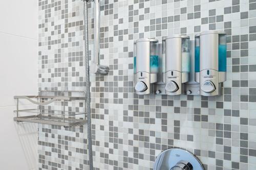 a shower with black and white tiles on a wall at Cozy & Private Studio in the Heart of Fremont in Seattle