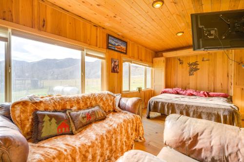 a living room with a couch and a large window at Salmon Vacation Rental with Mountain Views! in Salmon