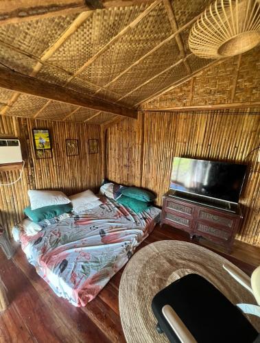 a bedroom with a bed and a tv in a room at Joseph Agricultural Farm in Ubay