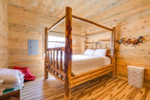 a bedroom with a bed in a log cabin at Salmon Vacation Rental with On-Site River Access! in Salmon