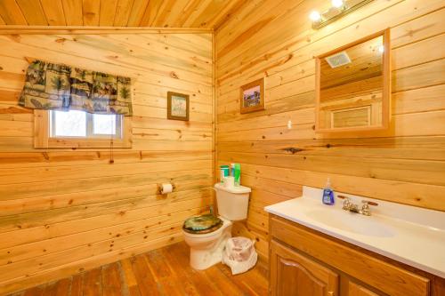 a log cabin bathroom with a toilet and a sink at Pet-Friendly Idaho Home on the Salmon River! in Salmon