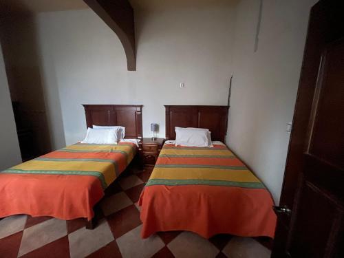 Postel nebo postele na pokoji v ubytování HOTEL PUEBLO GRANDE