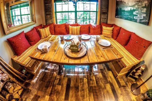 a wooden table in a living room with a couch at Woods Upon a Time Remodeled Cabin with Fireplace, Pond View & Firepit - Your Getaway Story Awaits! in Murphy