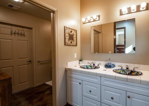 a bathroom with two sinks and a mirror at Great Sedona Home Sensational Views! in Sedona