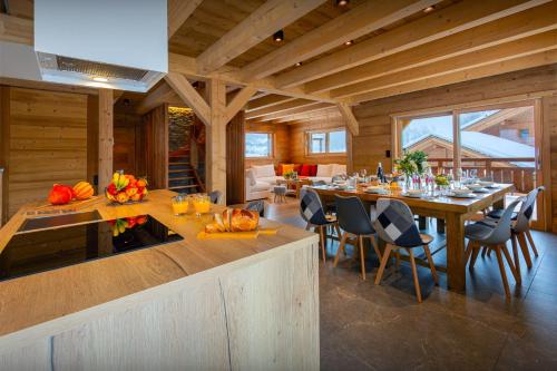 a kitchen and dining room with a table in a house at Chalet Trusquin - OVO Network in Le Grand-Bornand