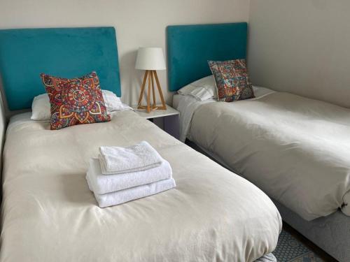 a room with two beds with towels on them at Departamento Río Valdivia in Valdivia