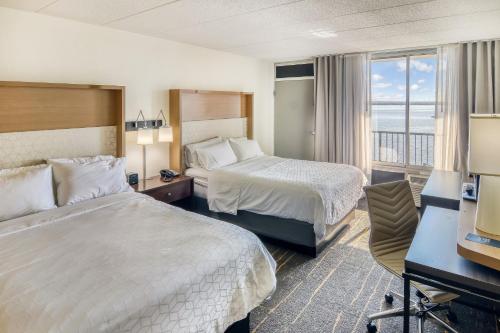 um quarto de hotel com duas camas e uma varanda em Holiday Inn Detroit Lakes, an IHG Hotel em Detroit Lakes