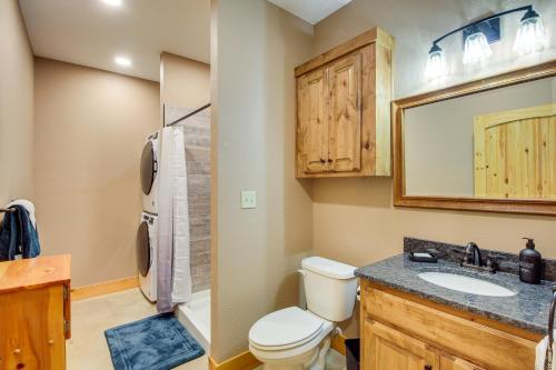 a bathroom with a toilet and a sink and a mirror at Rural Drexel Cabin on 30 Acres Unplug and Unwind! in Drexel