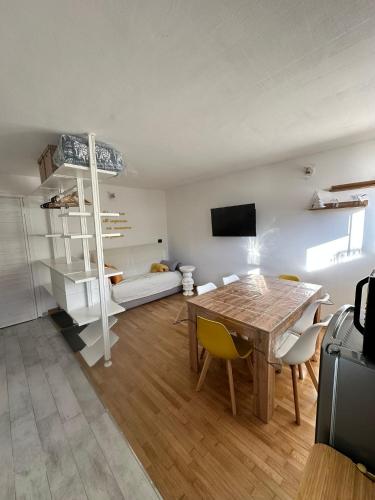 a living room with a table and a room with a couch at Casa Amanda in Sestriere