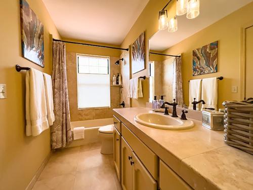 a bathroom with a sink and a toilet and a window at The Dahl House Of Sedona in Sedona