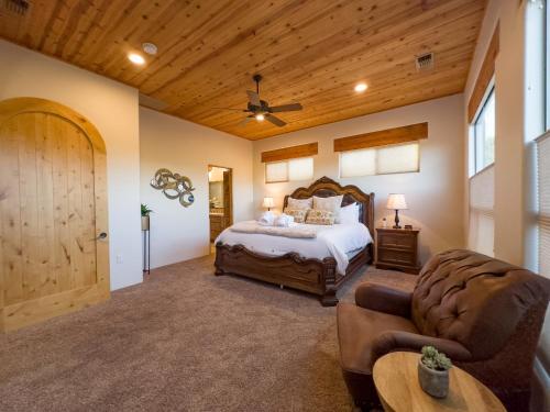 a bedroom with a bed and a wooden ceiling at Spectacular Sedona Destination with Pool & Spa in Sedona