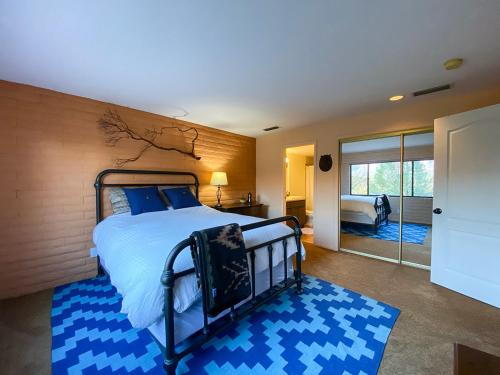 a bedroom with a bed and a blue rug at Open Style Home with Magnificent Views! in Sedona