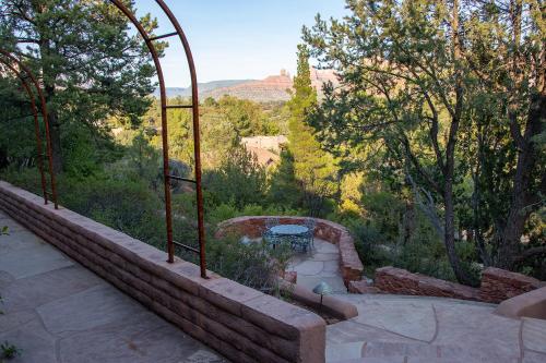 a stone patio with a view of a canyon at Open Style Home with Magnificent Views! in Sedona