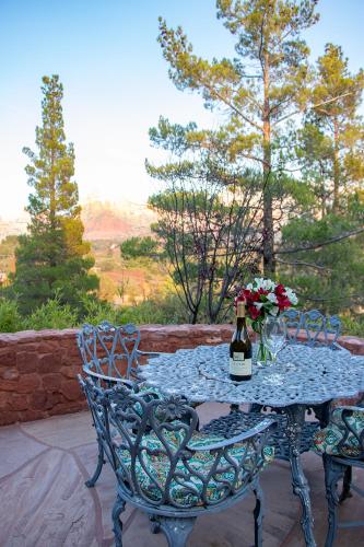 a table with a bottle of wine and flowers on it at Open Style Home with Magnificent Views! in Sedona