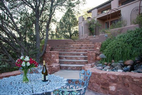 a table with a bottle of wine and flowers on it at Open Style Home with Magnificent Views! in Sedona