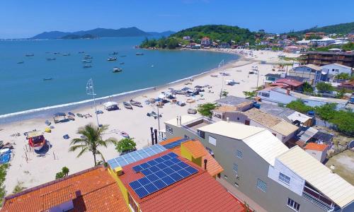 an aerial view of a beach with boats in the water at Casa de Anita Pinheira 30m da praia in Palhoça