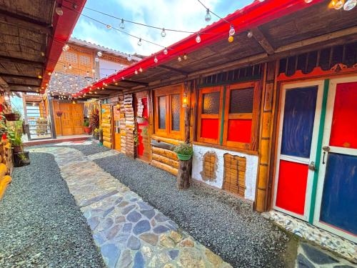 a building with colorful windows and a walkway at La Puesta Del Sol in Filandia