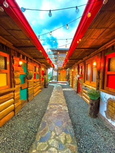 an empty corridor of a building with red lights at La Puesta Del Sol in Filandia