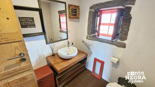 a bathroom with a sink and a mirror at Welcome to Paradise in Angra do Heroísmo