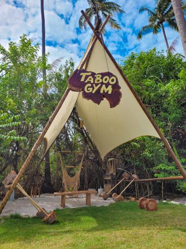 a large tent with a bench and a hammock at Taboo Milagres in São Miguel dos Milagres