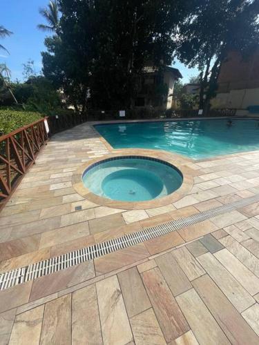 a small swimming pool in the middle of a patio at B12 Casa em Maresias condomínio a 50 metros da praia in Maresias