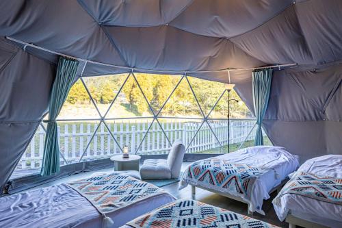 a bedroom with two beds in a tent at glampark Monte Rosa Hyogo in Kamikawa