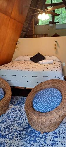 a bedroom with two beds and two wicker baskets at 7 CIELOS BACALAR. in Bacalar