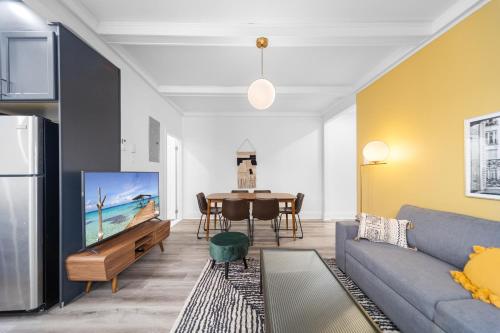 a living room with a couch and a table at Modern and cozy 4 bedrooms sleep 12 in Montréal