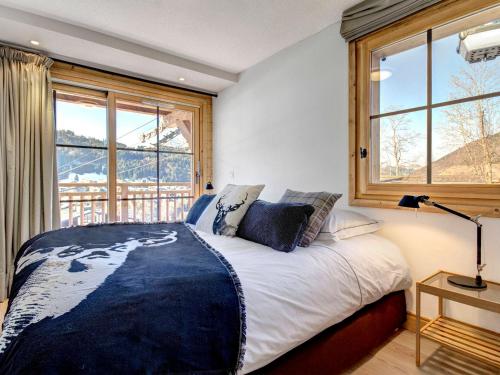 a bedroom with a bed with a large window at Appartement Morzine, 4 pièces, 6 personnes - FR-1-627-38 in Morzine