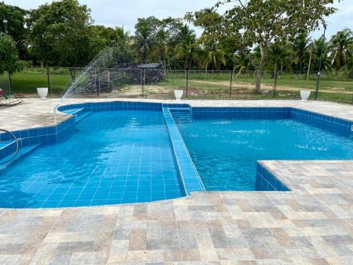 a swimming pool with a water fountain at Finca Hotel Villa Manuela in Sahagún