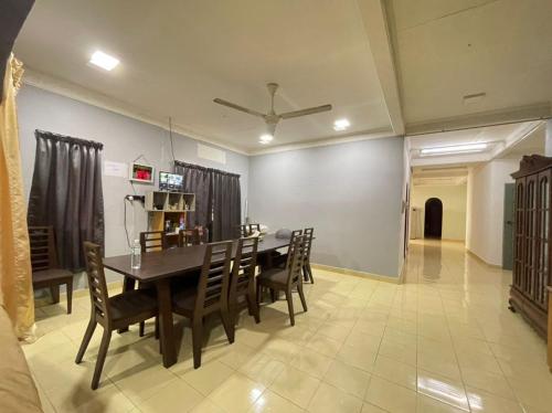 a dining room with a table and chairs at Family's Homestay in Kuala Terengganu