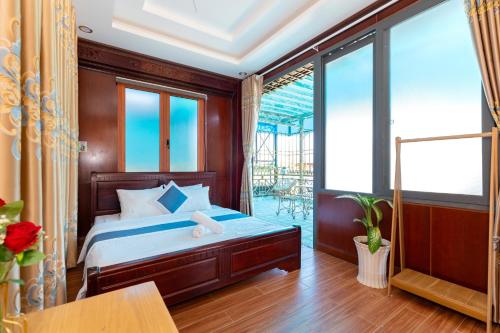 a bedroom with a bed and a large window at Ngọc Thị Villa in Vung Tau