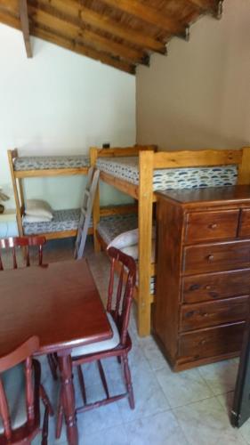 Cette chambre comprend 2 lits superposés, une table et un bureau. dans l'établissement CASA PARA DESCANSAR, à Mar del Tuyú