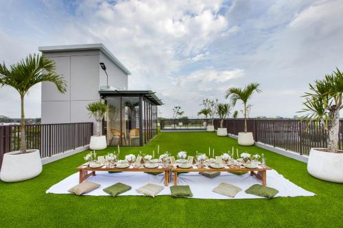 a dining table on the lawn of a house at Kinaralana Hotel Yogyakarta in Yogyakarta