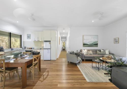 a kitchen and a living room with a table and chairs at Sweetacres Hunter Valley in Pokolbin