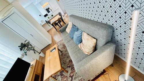 a living room with a gray couch with pillows at Eldor Nishikoujiya Apartment by Tranova in Tokyo