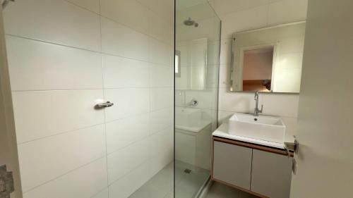 a white bathroom with a sink and a shower at Remanso de Mar in Mar del Plata